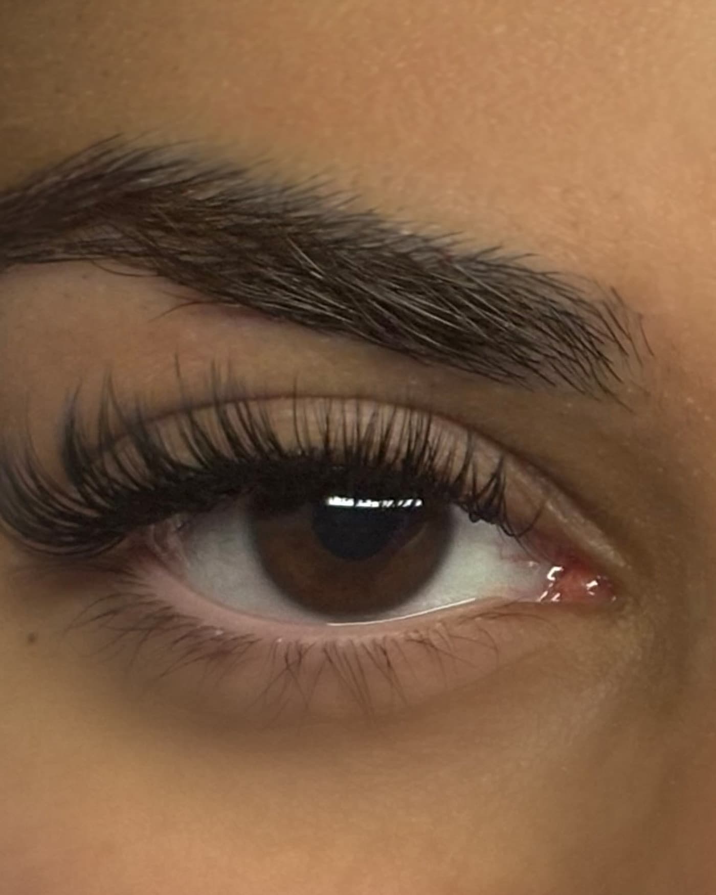 Close-up of a client's eye with lash extensions by Lashout