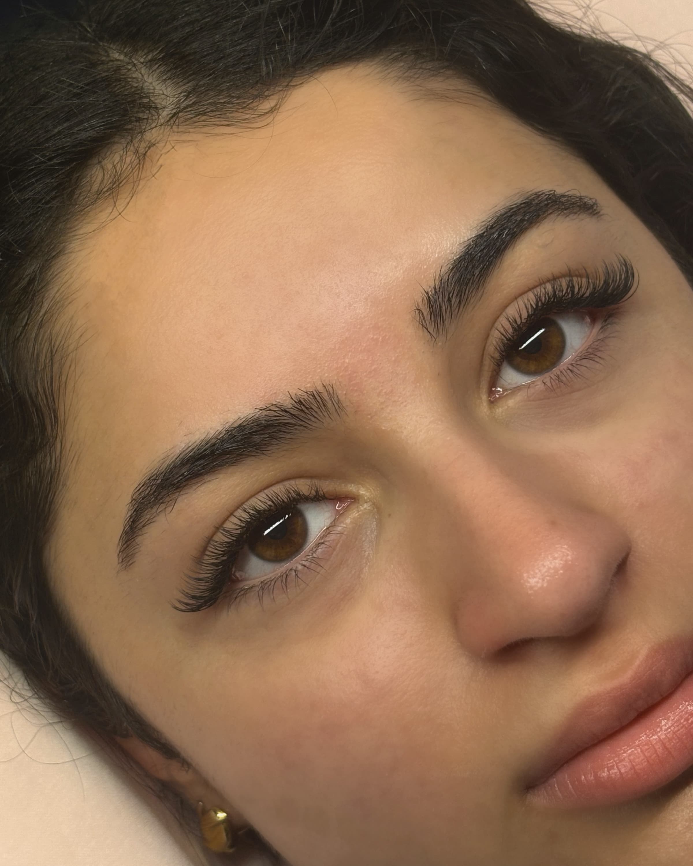 A Lashout client on the lash bed after her appointment